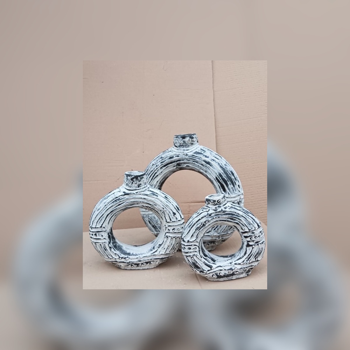 Textured white ceramic ring vessels