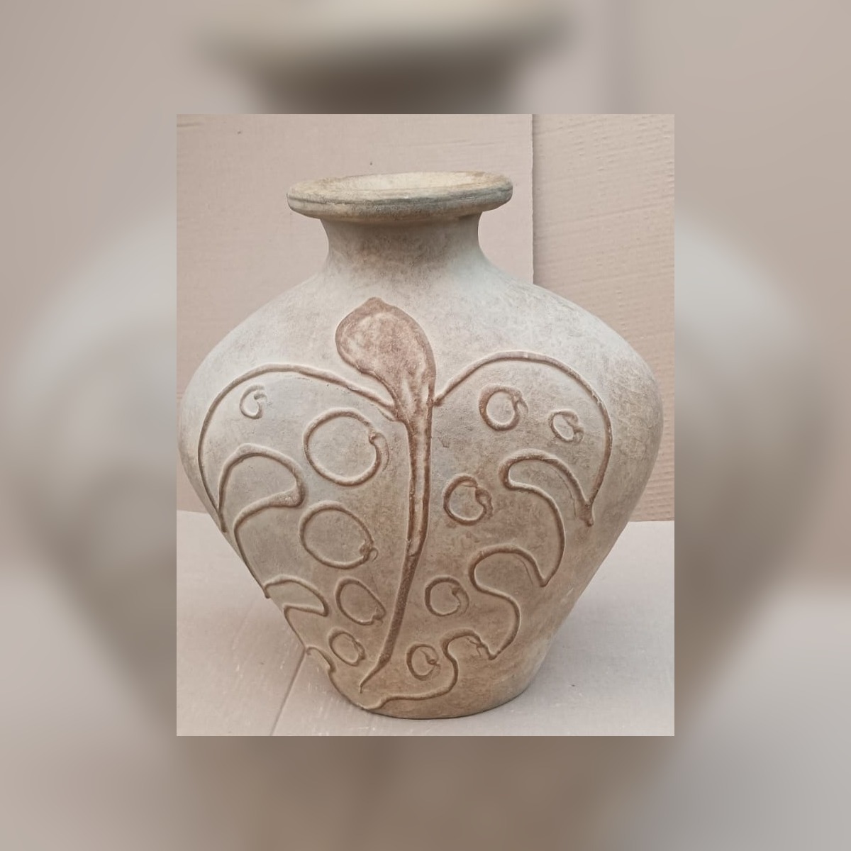 Decorative terracotta vessel with carved leaf motif
